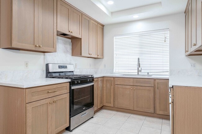 Building Photo - Gated Townhome with Updated Kitchen and Private Backyard