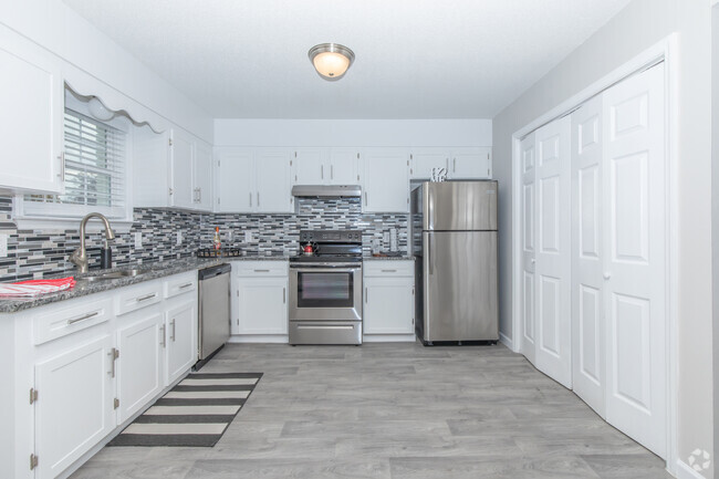 White shaker cabinetry, stone countertops, plank flooring - Elements44