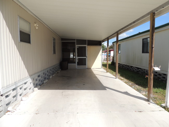 CARPORT WITH SCREEN ROOM AND SHED - 7434 Demure Ln