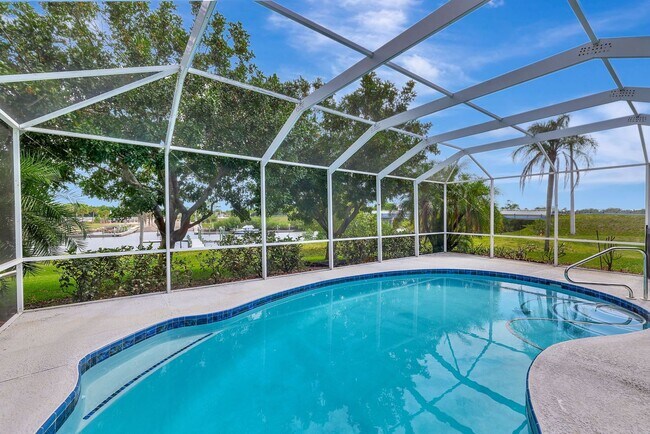 Building Photo - A BOATER'S PARADISE WITH THIS STUNNING 3 BEDROOM, 2 BATH WATERFRONT POOL HOME W/DOCK & BOAT LIFT ...