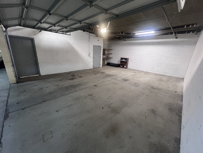 The garage: the light gray door is the one that opens to the stairs going to the condo first floor - 430 W Wilson Ave