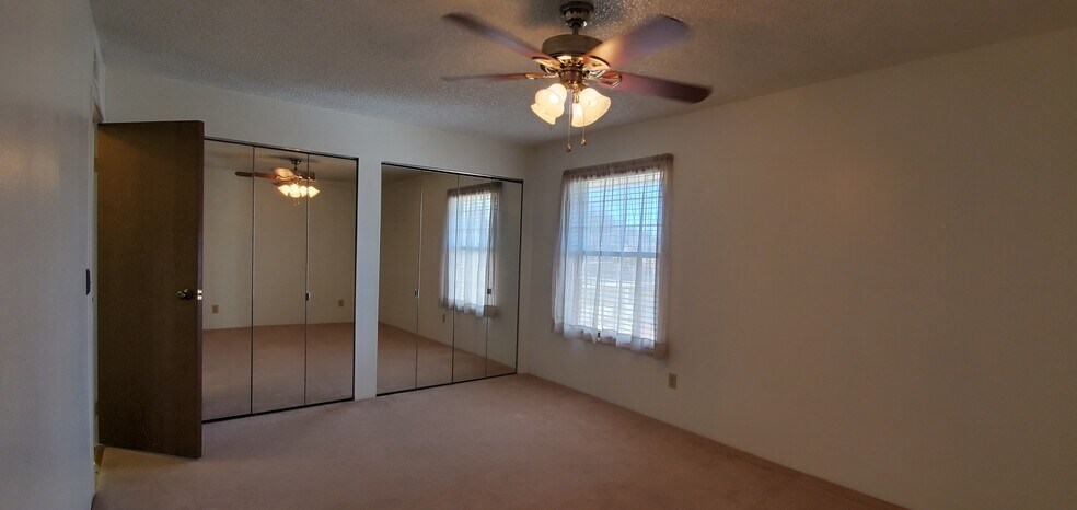 Master bedroom with two full size closets with mirrored doors. - 10251 W 44th Ave