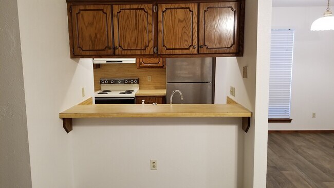 Kitchen with bar from living room view - 910 Acacia Circle