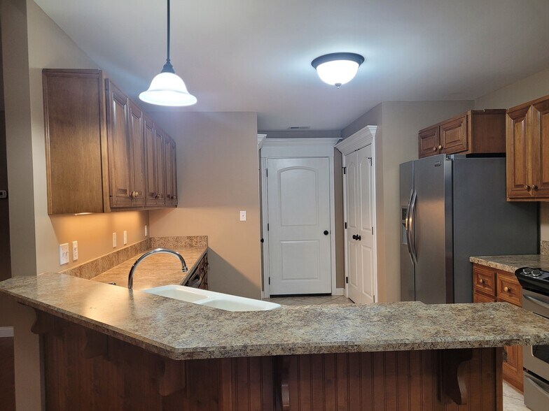 Open kitchen with sttainless steel electric stove, dishwasher, refrigerator and microwave - 528 N 2nd St