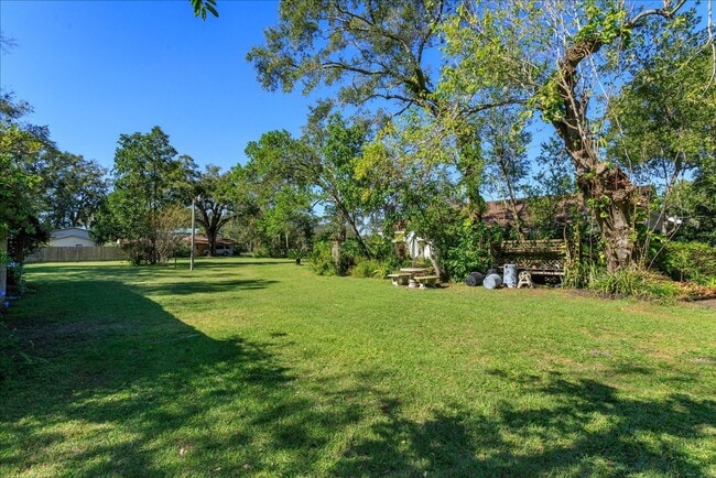 Building Photo - Run don't walk for this one of a kind beautifully maintained Old Florida Charmer on a park like d...