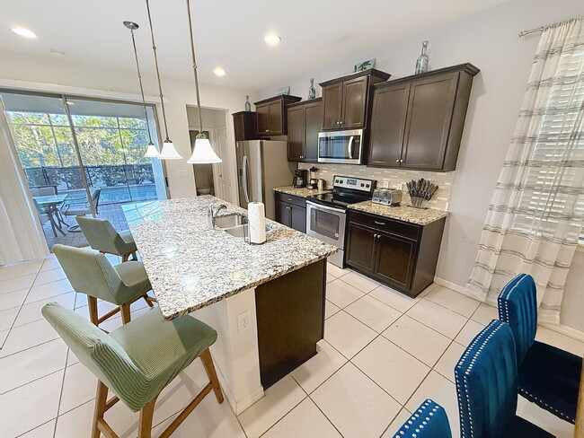 Building Photo - Welcome home to the fully furnished 5-bedroom, 5.5-bathroom private pool home located in Windsor ...