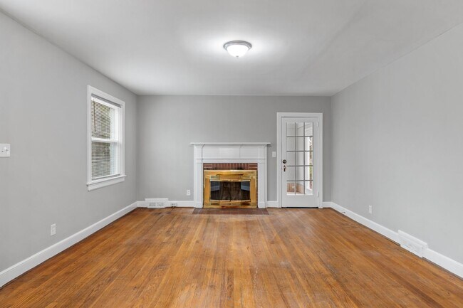 Building Photo - Brick home, Two Story, Hardwoods, DR, 2 Sun Rooms, FP, Carport!.