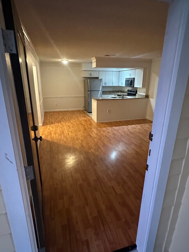 Updated, open floor plan with laminate flooring in the living areas. - 100 Fairway Park Blvd