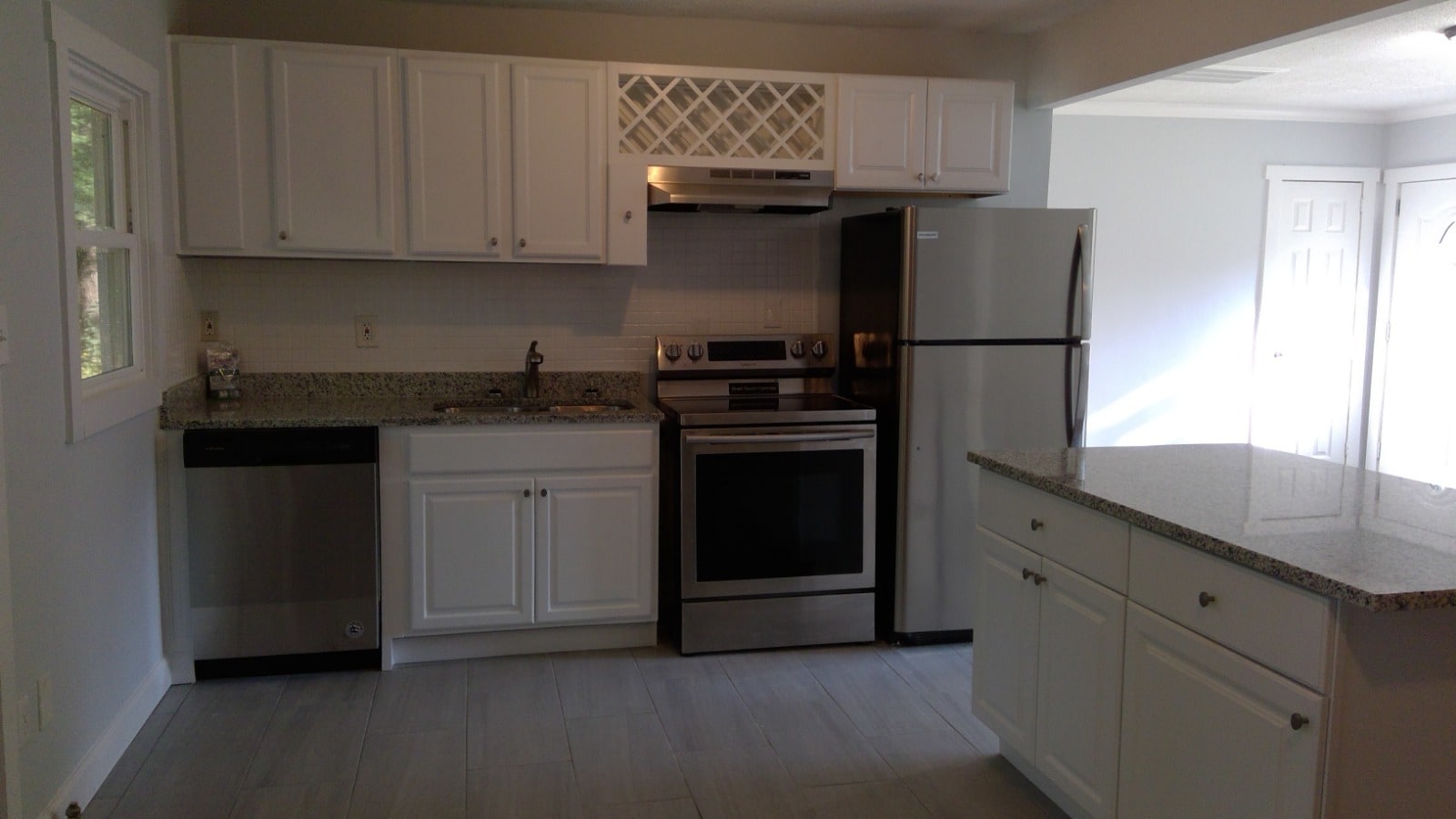 Kitchen with white cabinets, stainless appliances and granite counter tops - 680 Tom Read Dr