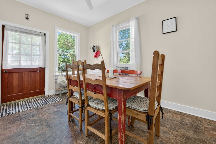 Dining room with South and West facing windows and ceiling fan. - 302 Van Deusen St