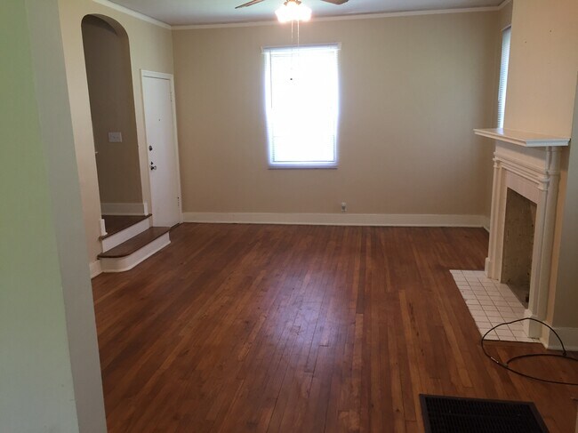 Living Room with Fireplace and Arched Stairwell - 1726 Saint Mary St