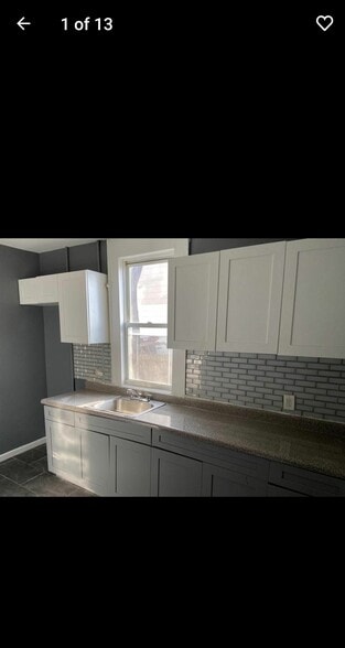 Modern kitchen with stove and refrigerator - 101 Bedford St