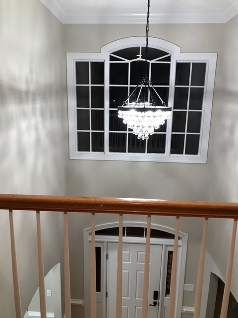 New modern chandelier hangs above the foyer - as seen from upstairs landing - 1977 Culpepper Ln