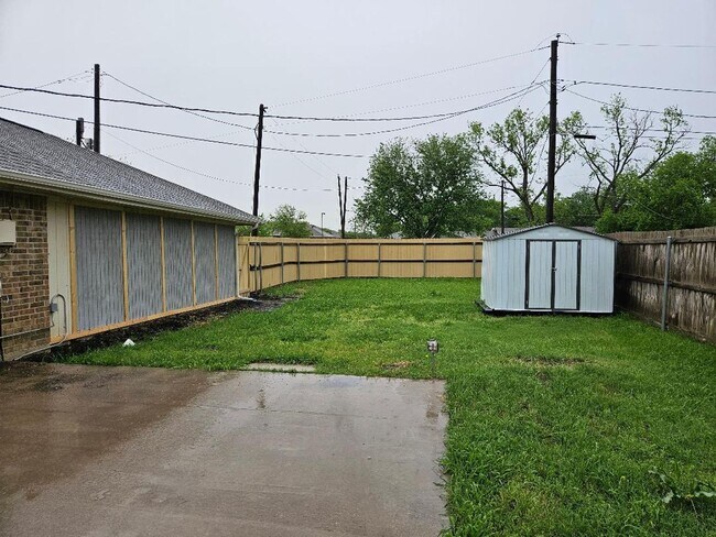 Building Photo - Three bedroom and two bathroom nicely remodeled with new flooring. Large wood fenced backyard