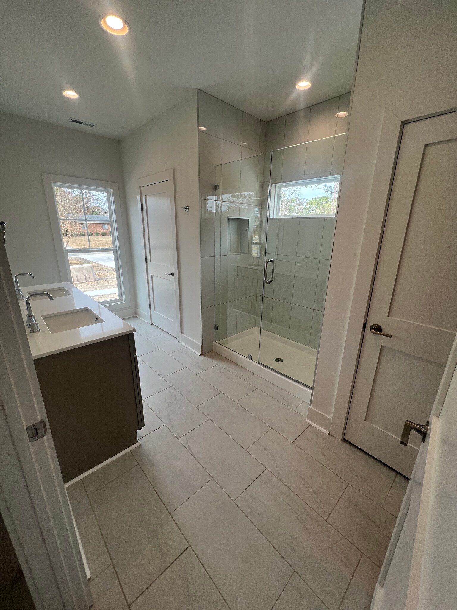 master bathroom with tile shower, water closet, and linen closet - 132 Hargrove Dr