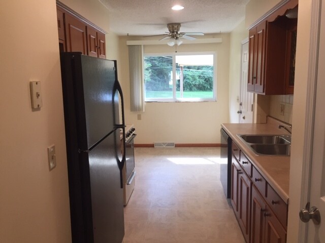 Kitchen with table area and backyard view. - 12601 Blue Ridge Ext