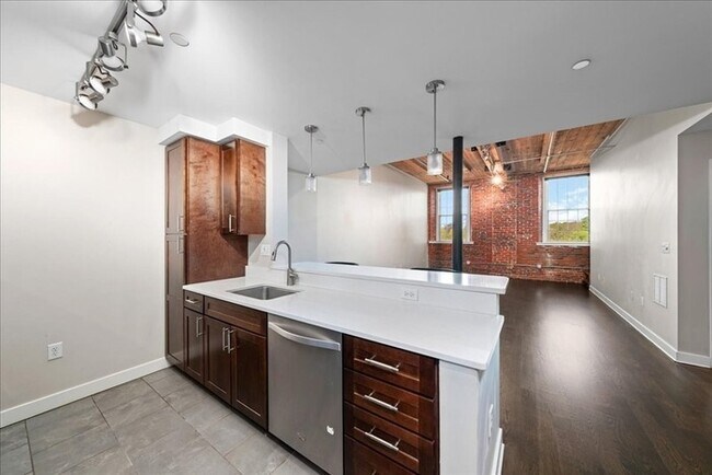 Building Photo - Stylish Industrial Loft with Exposed Brick, High Ceilings & Modern Kitchen