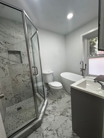Full bathroom with free standing bath tub looking out backyard - 313 N 37th St