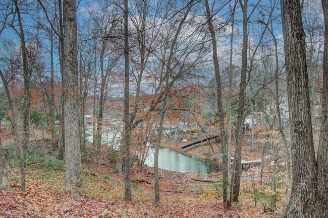 Building Photo - Nestled on a spacious, private wooded wate...