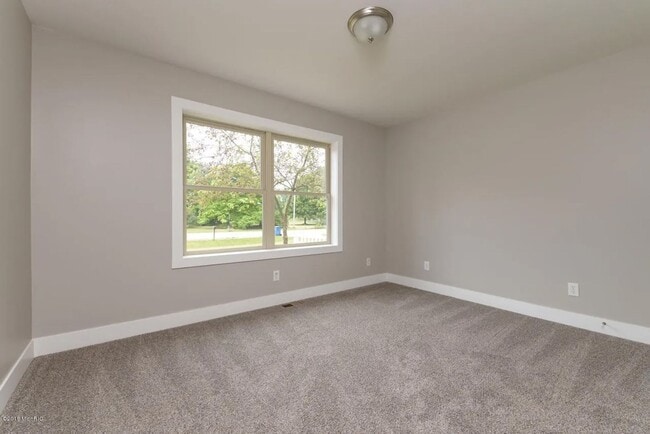 Building Photo - Spacious 3BR Duplex with Finished Basement & 2-Car Garage in Otsego