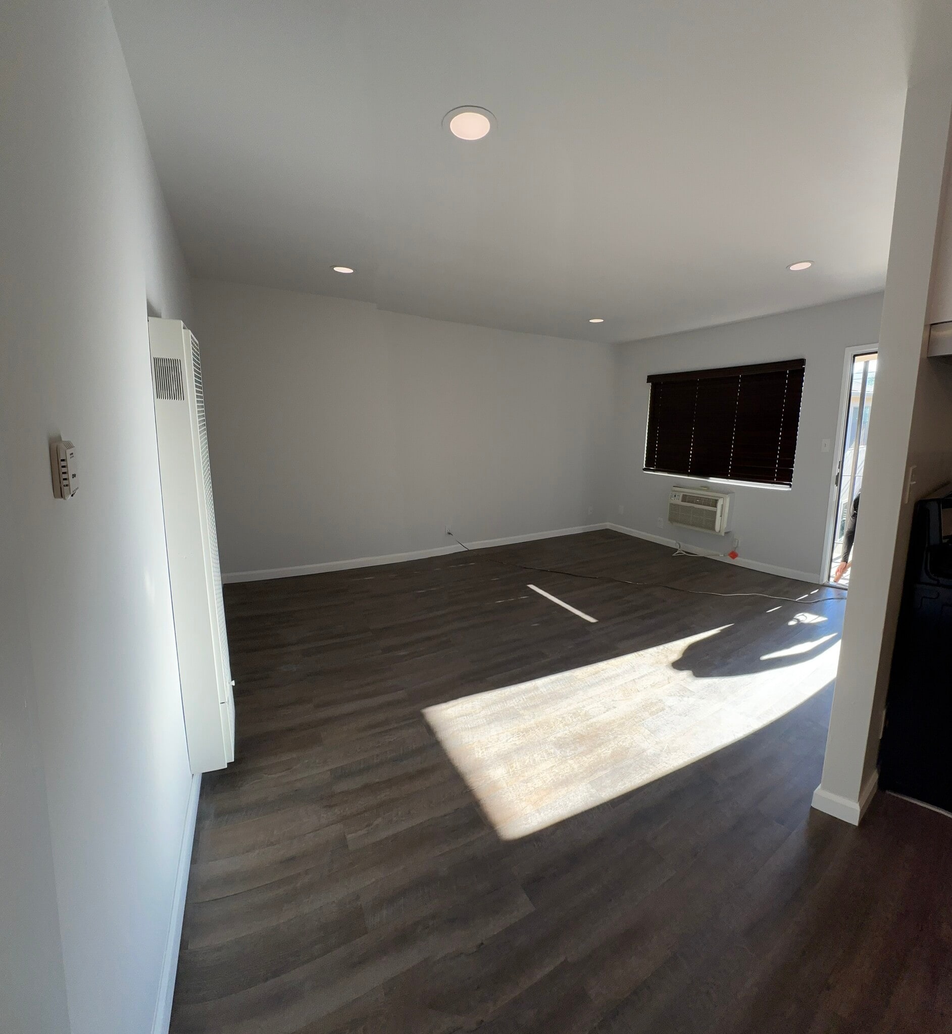 Living space with wall unit air conditioner. - 1016 Western Ave