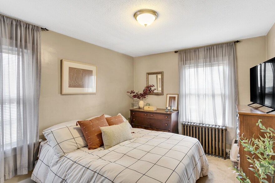 Comfortable secondary bedroom offering flexibility for family, guests, or additional workspace. - 203 Richbarn