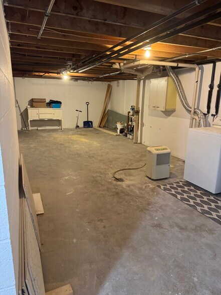 Spacious basement with ample storage space—perfect for organization or hobby projects. - 328 N Allen St