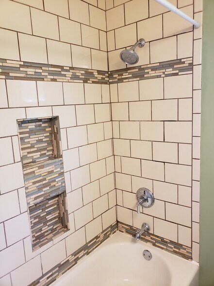 Two niches in bathroom tile wall for shampoos and soap, along with new shower head and fixtures. - 10106 Wingfield Rd