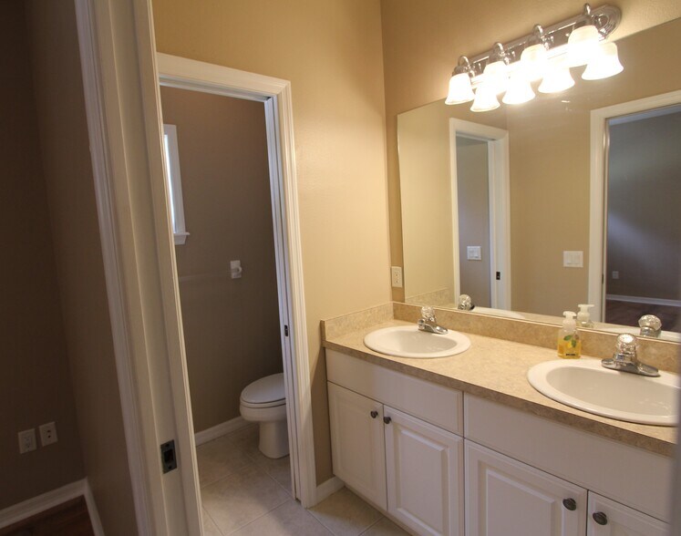 Master bath dressing area with water closet/sliding pocket door - 37410 Picketts Mill Ave