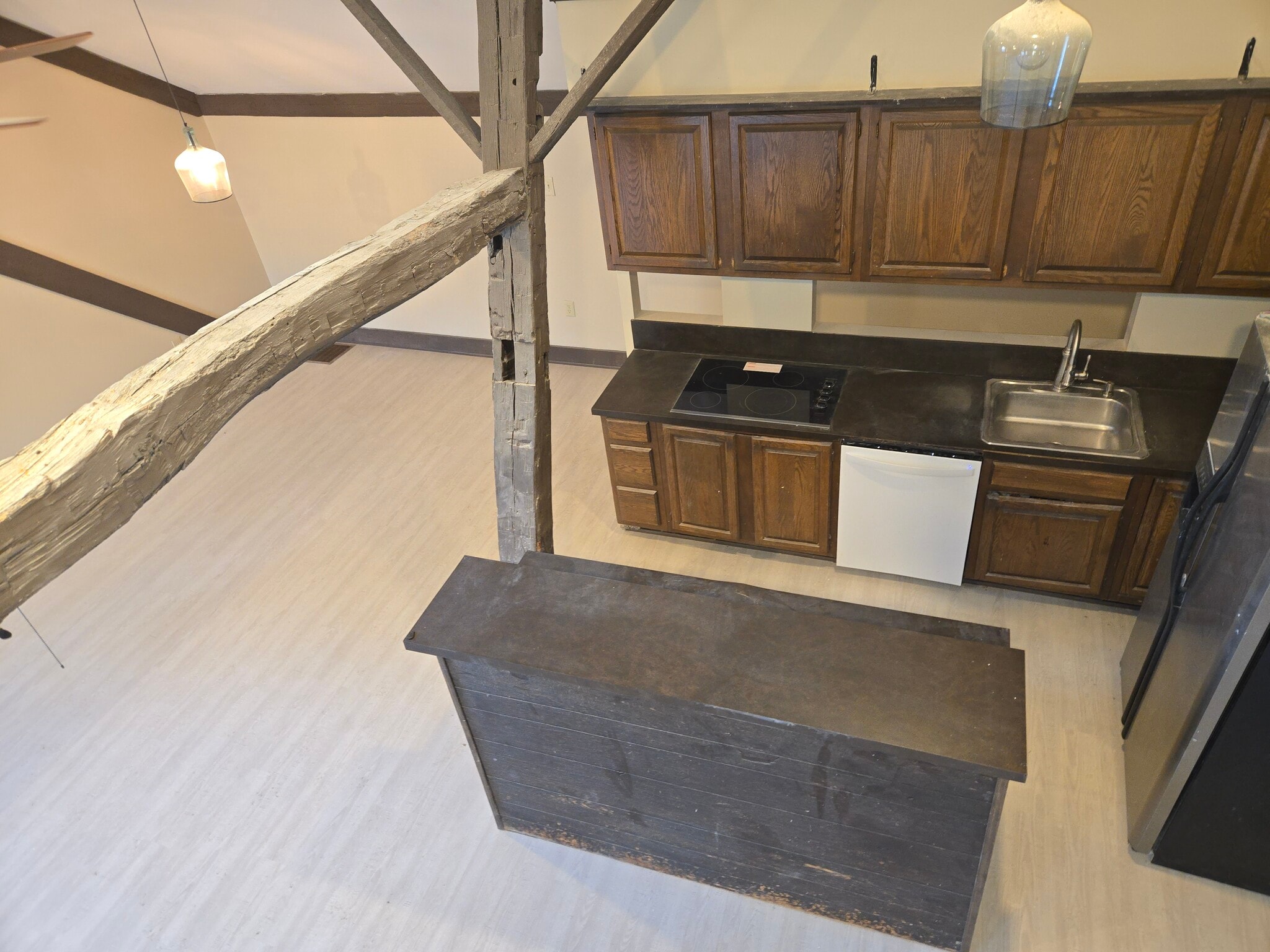 Loft area looking down to kitchen with exposed beams - 60 W Winter St