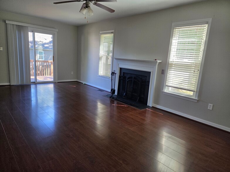 Living Room with rear door leading to deck and fenced-in yard - 12604 Paget Ct