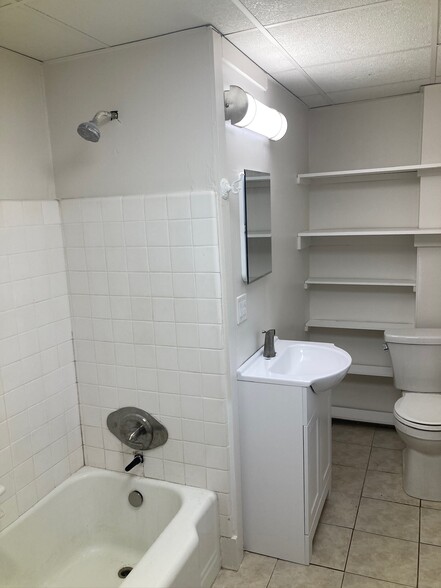 Bathroom with tub and lots of shelving - 227 E Hector St