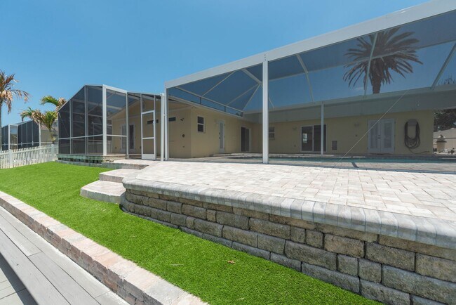 Building Photo - Live the ultimate Space Coast waterfront lifestyle at this stunning beachside canal home in Satel...