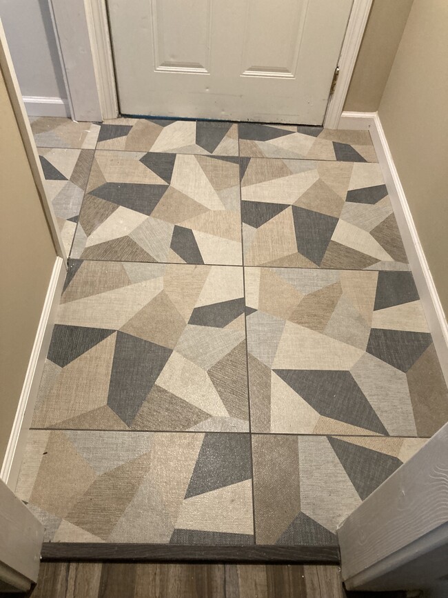 Tile floors leading to downstairs bathroom. - 1419 N Hamilton Ave