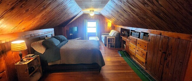 Upper level staged as a bedroom, demonstrating comfortable sleeping and living space. - 2923 Arthur St NE