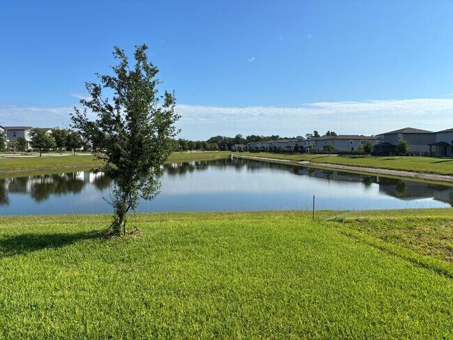 Building Photo - Like-New 4 Bedroom 3 Bath with Pond View & Two Living Spaces — Minutes to South Lake Nona