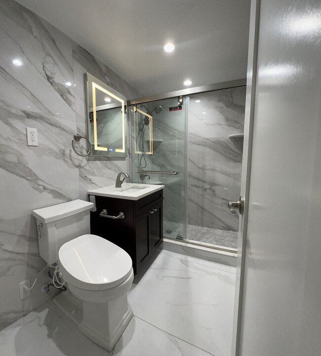 Bathroom with high end fixtures, porcelain tiled wall and floors - 730 24th St NW