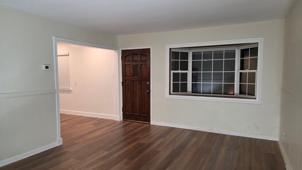 Living Room - view towards entrance and bay window - 16825 S Berendo Ave