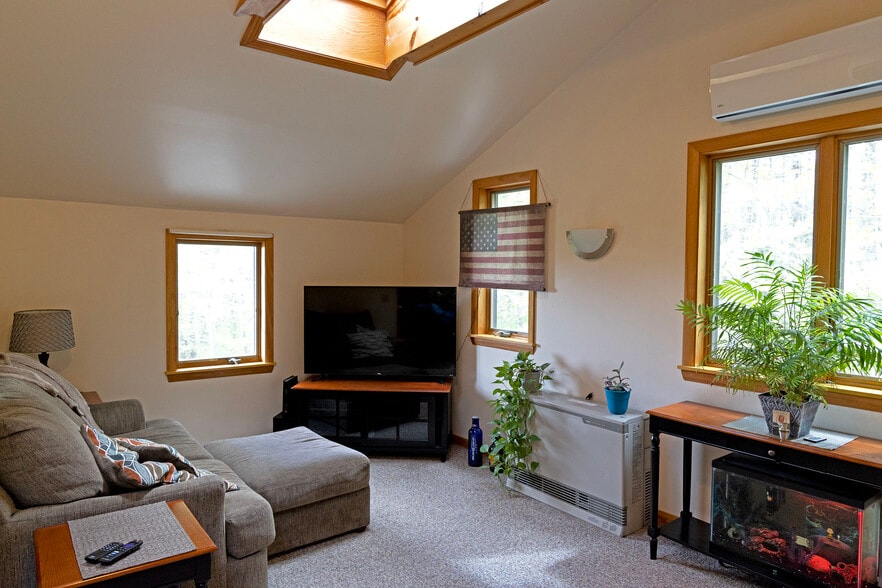 Front/side of living room, showing one of 3 skylights - 64 Gardner Rd
