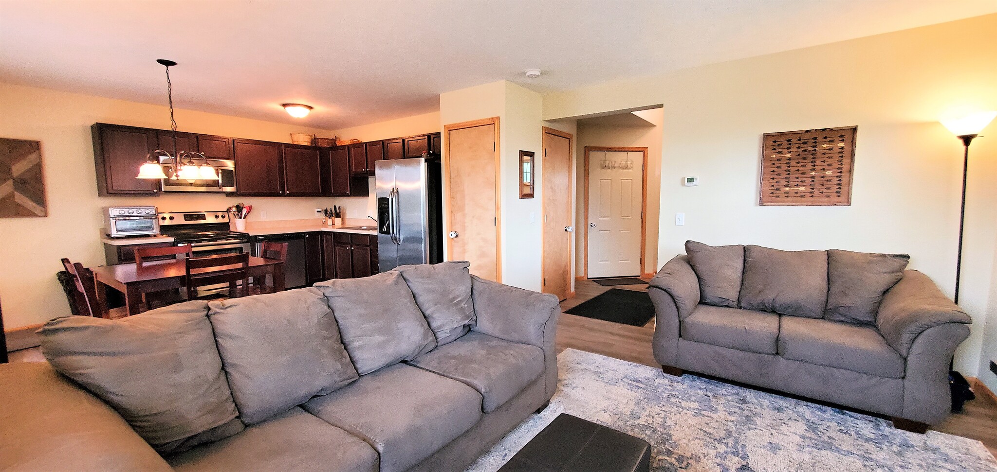 Living space/kitchen/front entry. (photo from neighboring unit with the same layout) - 1756 St Joseph St
