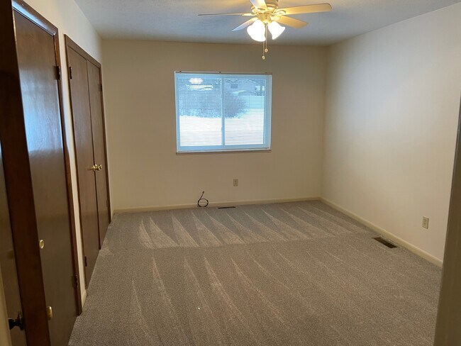 Master bedroom with ceiling fan and 2 closets - 8410 N Akins Rd