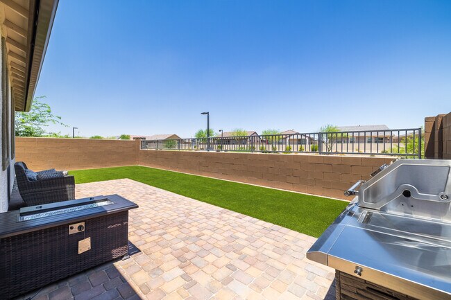 Rear yard with fire table and BBQ - 8924 W Solano Dr