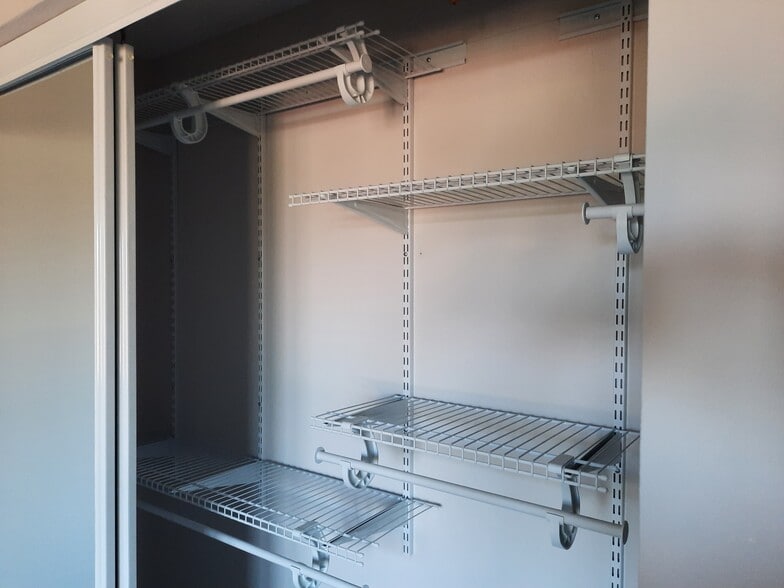 Adjustable shelving in guest bedroom closet with sliding mirror doors - 434 Clinton Pl