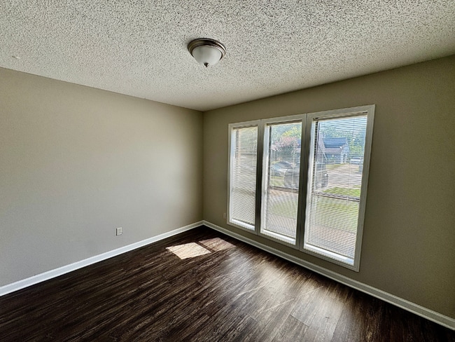 Building Photo - Charming 3BR/2BA Near Southwind | Soaring Vaulted Ceilings, Brick Fireplace & Fenced Yard