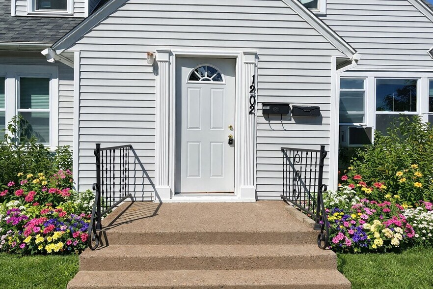 Clean kitchen with ample cabinet storage and functional workspace in this pet-friendly Wausau apartm - 1202 S 11th Ave