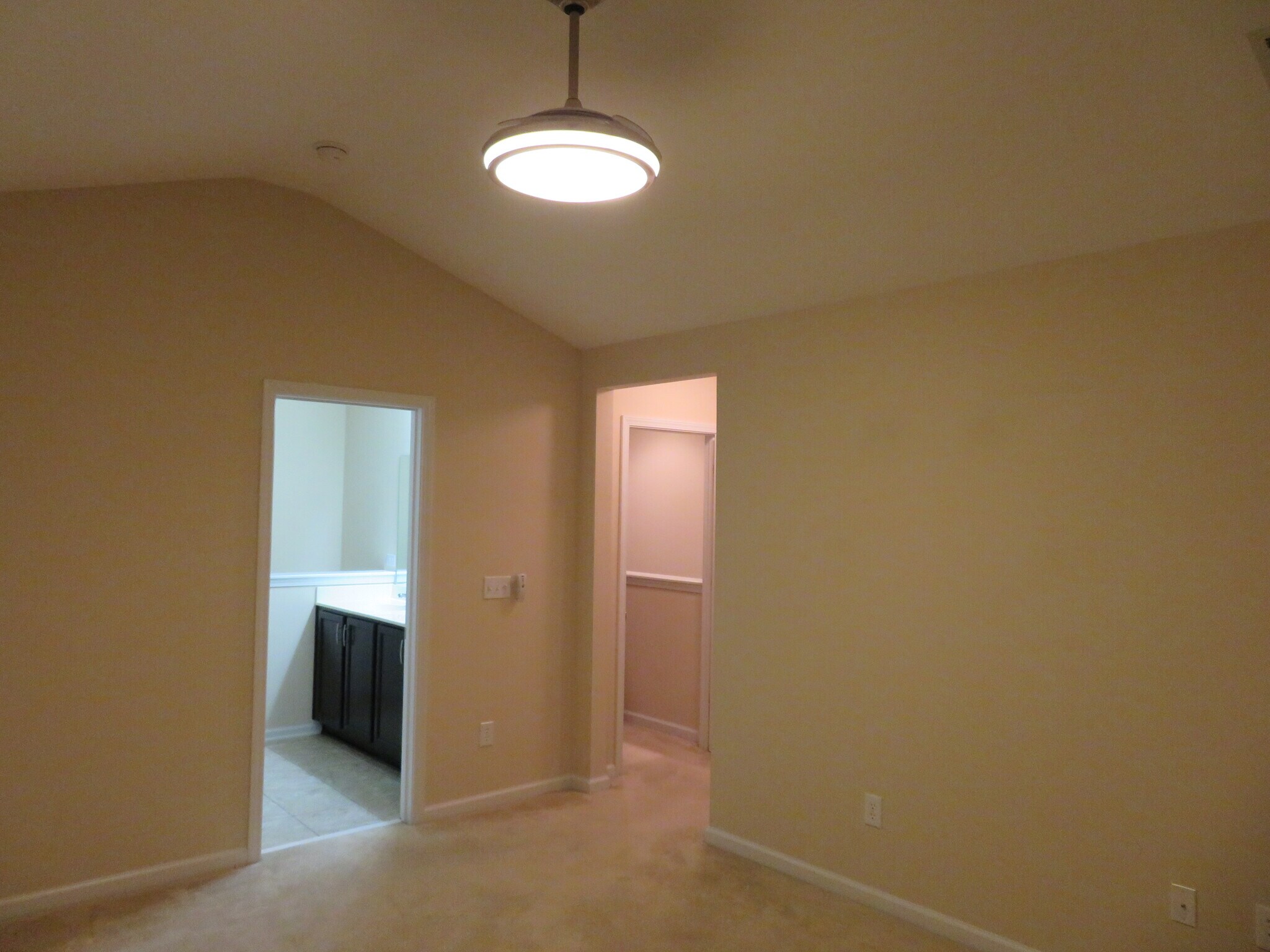 Master Bedroom w vaulted ceiling & carpet;ceiling fan w hidden blades.Bath left,Walk-in Closet right - 2496 Stadium Dr