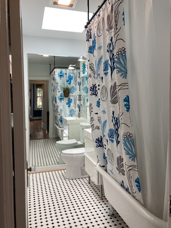 Upstairs bathroom, with skylight and wall mirror. - 526 24th St NE