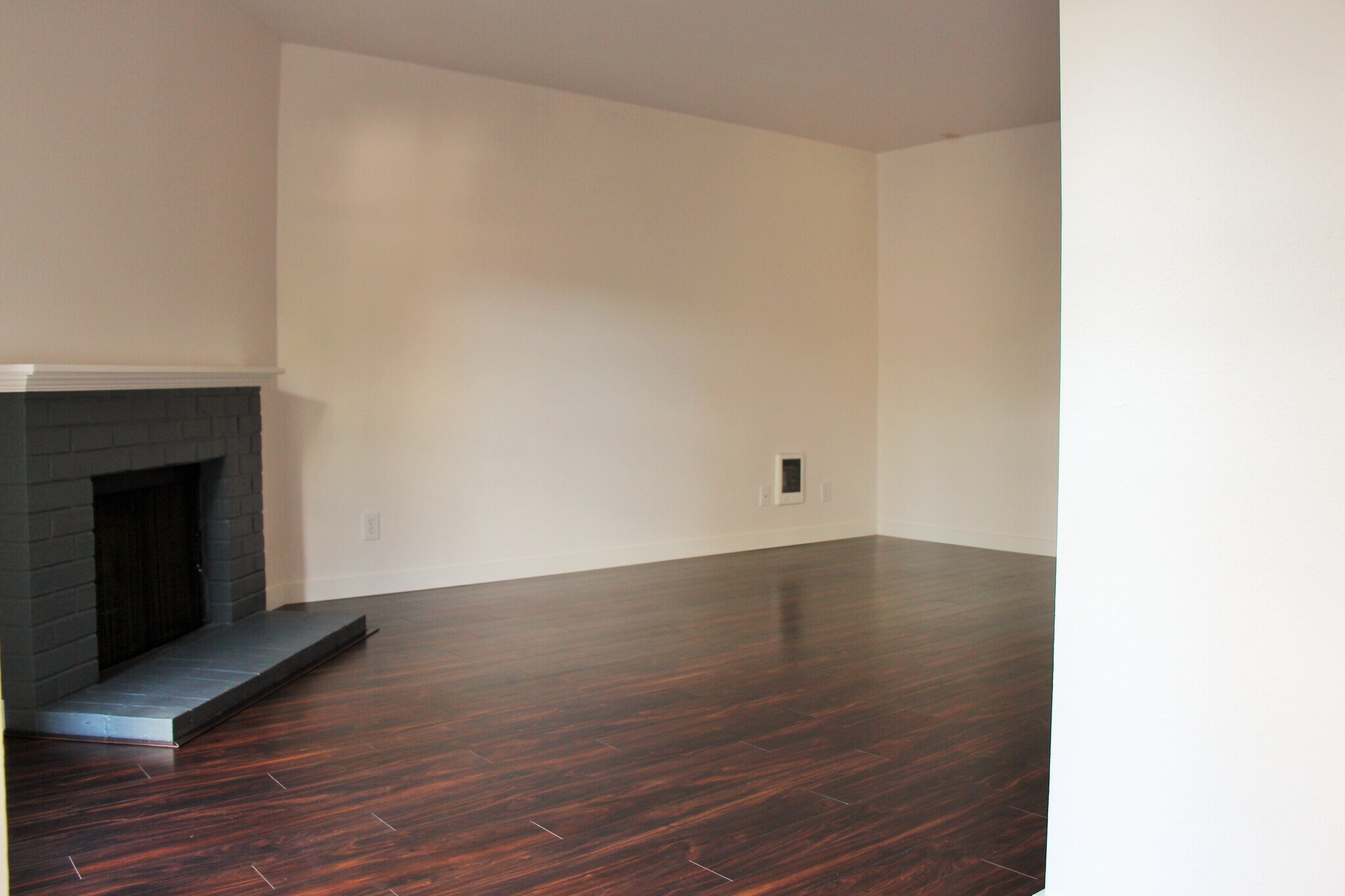Living room is spacious and features hardwood laminate flooring throughout - 10418 Northeast 32nd Place
