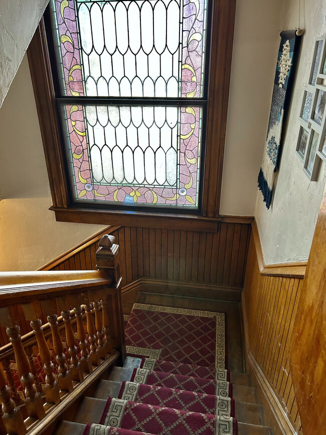 Experience timeless elegance with this beautifully crafted stained glass staircase. - 1458 N Gaylord St