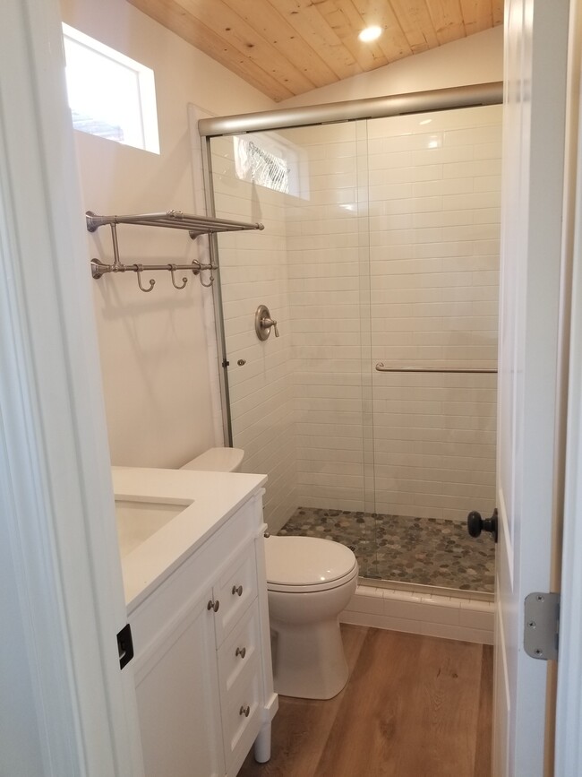 Main bathroom with new stone topped vanity, and large stone floor shower - 6832 Zelzah Ave